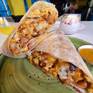 Hearty breakfast burrito with eggs, Nalu pork, cheese, green onion, and tots at Nalu Vida Venice Beach.