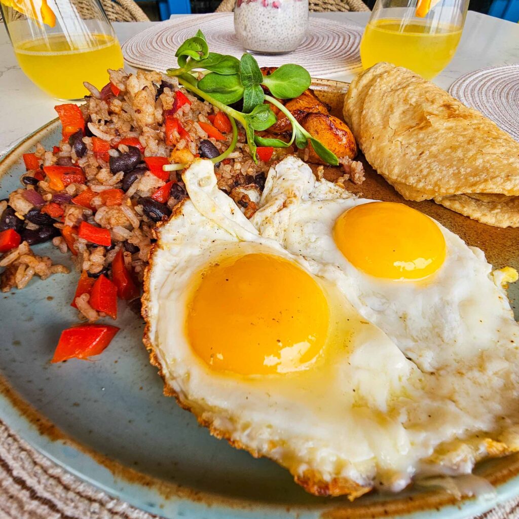 Brunch in Venice Beach CA - Traditional huevos con gallo pinto with fried eggs, rice and beans, plantains, and tortillas at Nalu Vida Venice Beach.