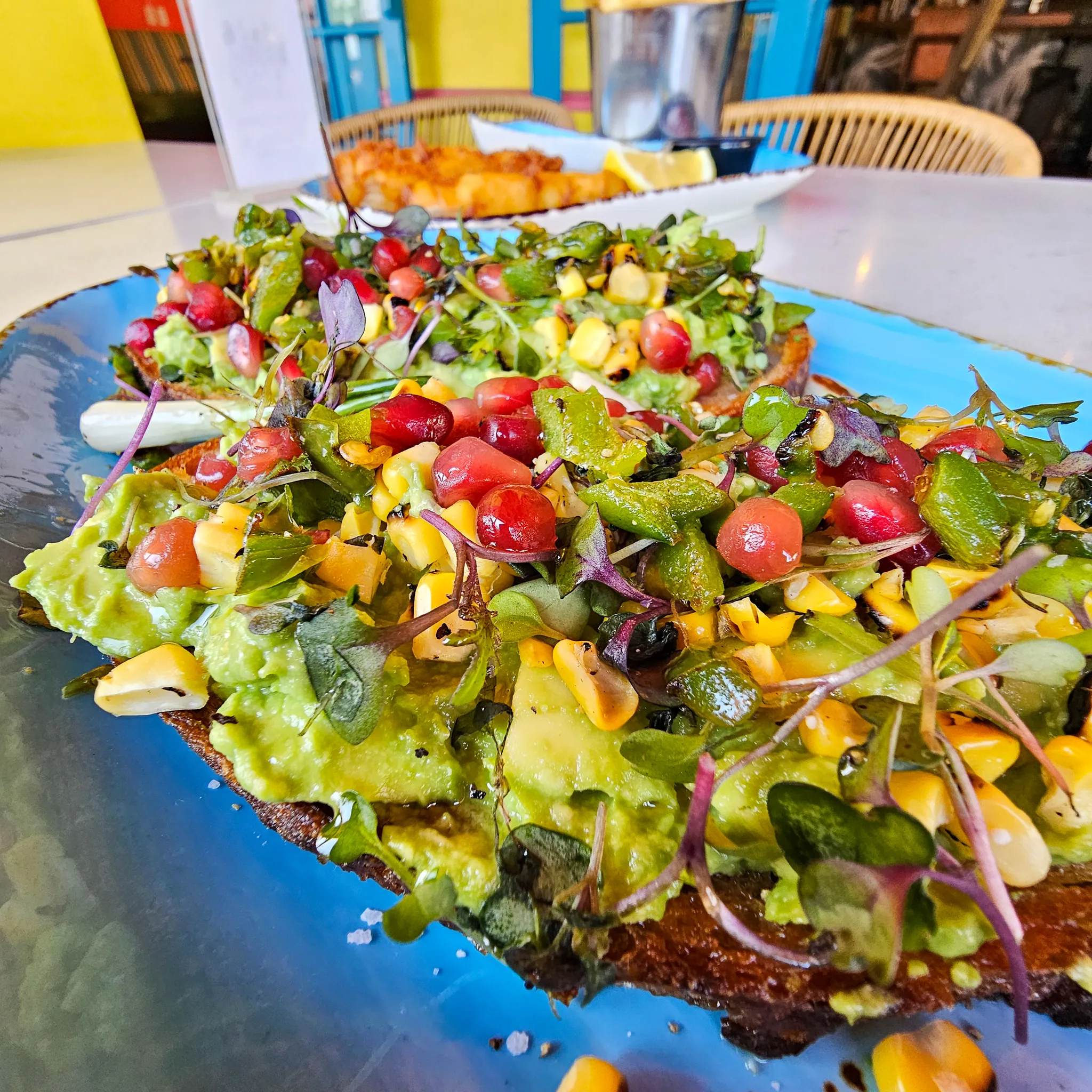 Avocado Toast at Nalu Vida Venice Beach restaurant, roasted corn, black sesame, charred serrano